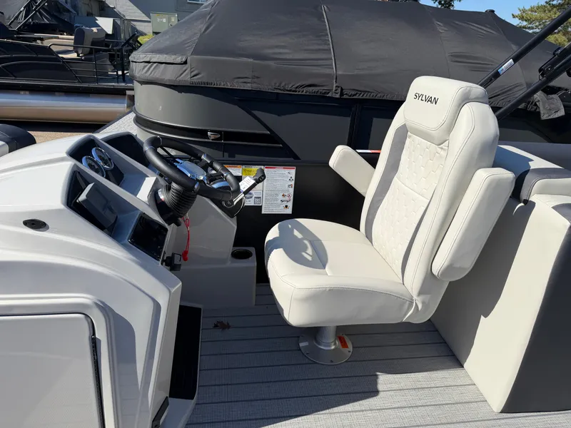 Slide: The Image of The image shows the helm of a 2027 Sylvan Q-22 LZ with a white captain's chair. - 15