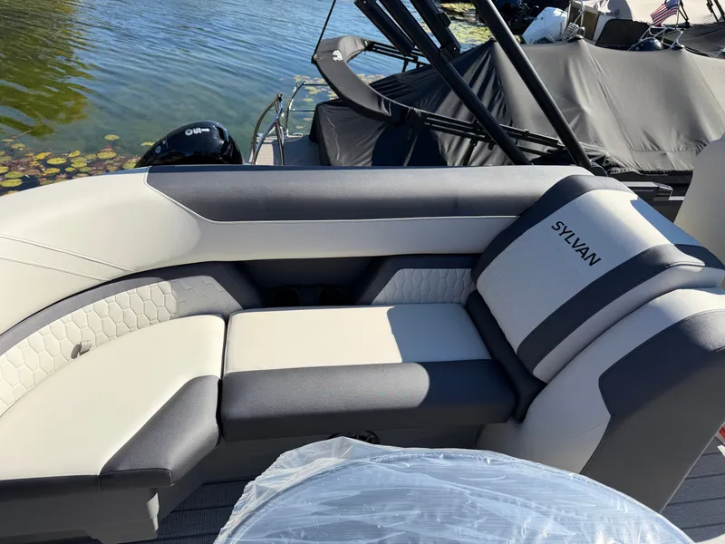 Slide: The Image of The image shows the sleek seating design of a 2027 Sylvan Q-22 LZ with gray and white upholstery. - 22