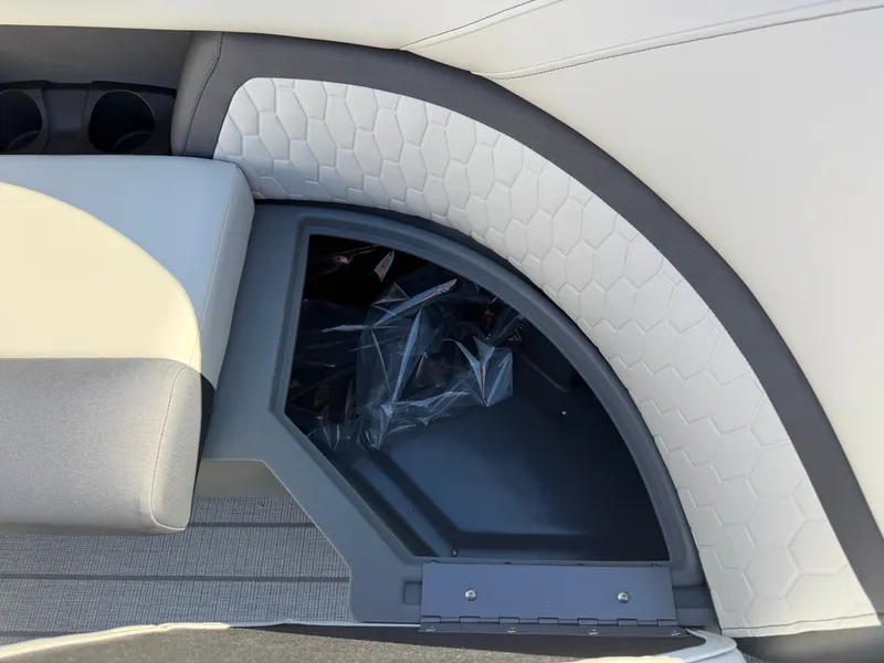 Slide: The Image of Close-up of a seating area with gray and white upholstery and a storage compartment. - 27