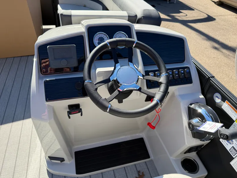 Slide: The Image of The image shows the helm of a 2027 Sylvan Q-22 LZ with a modern steering wheel and instruments. - 16