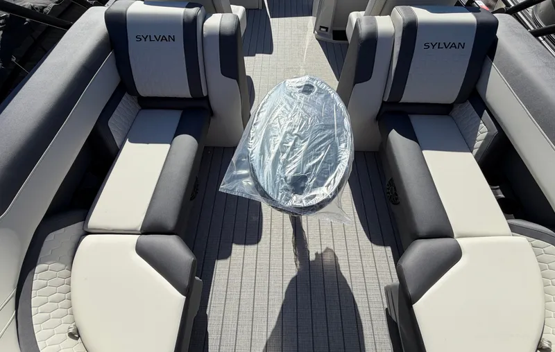 Slide: The Image of Interior of a 2027 Sylvan Q-22 LZ with gray and white seating and a table. - 20