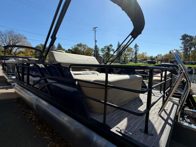 Slide: The Image of Sylvan MIRAGE 822 CLZ DH 2027 at a sunny dock with seating area and railing. - 2