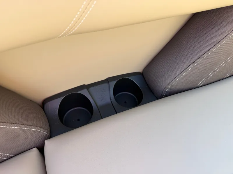 Slide: The Image of Close-up of two cup holders between beige and gray upholstery on a boat. - 7