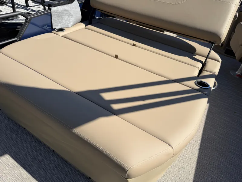 Slide: The Image of Beige lounging area on a boat with cup holders and shadows from the railing. - 22