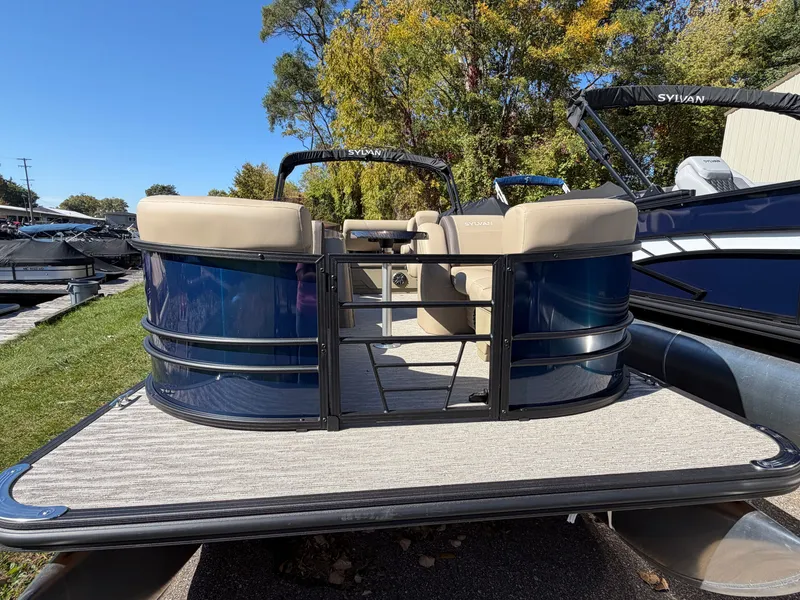 Slide: The Image of The image shows a Sylvan MIRAGE 822 CLZ DH pontoon boat with blue and beige accents. - 1
