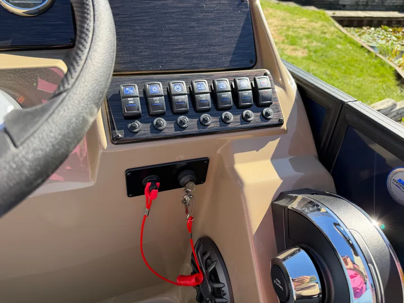 Slide: The Image of Dashboard with switches and controls on a Sylvan MIRAGE 822 CLZ DH boat. - 18