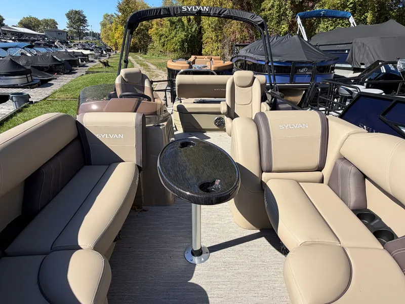 Slide: The Image of Sylvan MIRAGE 822 CLZ DH 2027: Spacious pontoon boat with beige upholstery and a central table. - 4