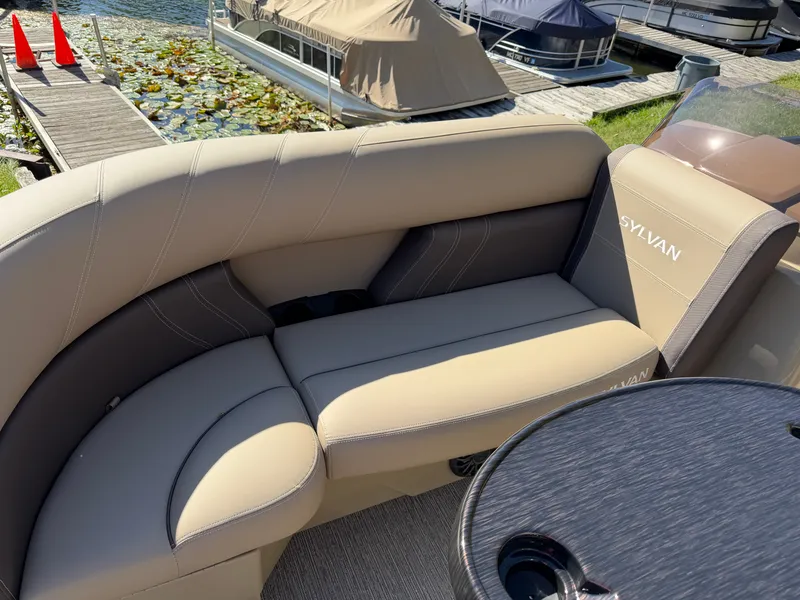 Slide: The Image of Sylvan MIRAGE 822 CLZ DH 2027: Elegant seating area with beige upholstery, docked at a pier. - 6
