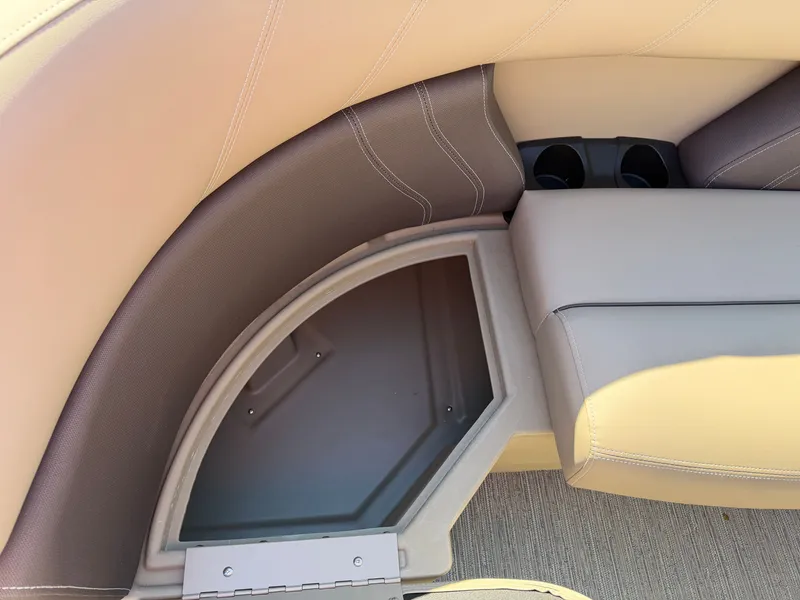 Slide: The Image of Close-up of a seating area with beige and gray upholstery and cup holders. - 8