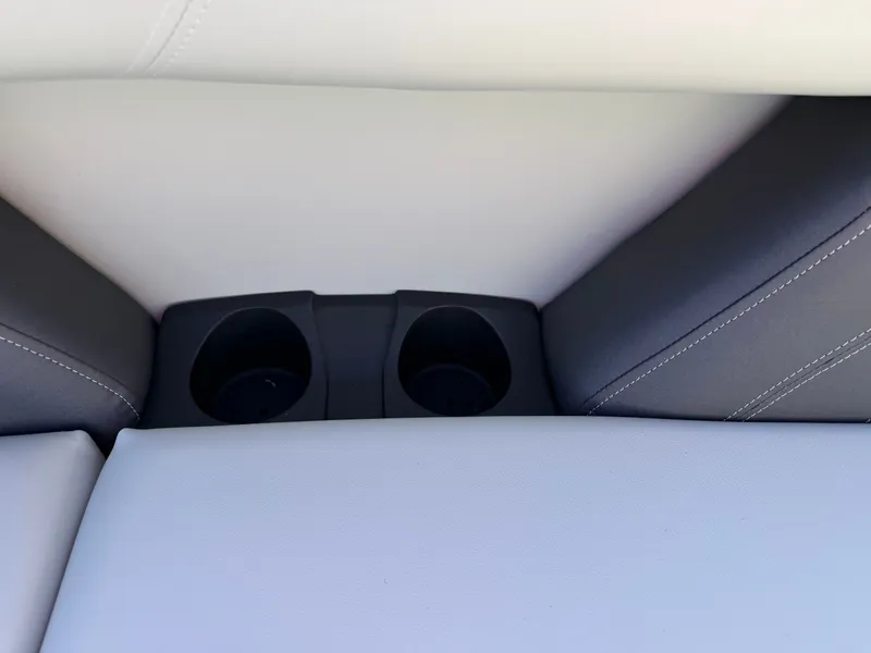 Slide: The Image of Close-up of two cup holders in a gray and white seating area. - 7