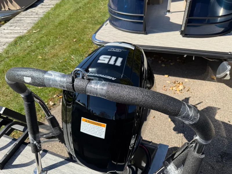 Slide: The Image of A 2027 Sylvan Mirage 822 LZ with a Mercury 115 HP outboard motor, on a trailer. - 3