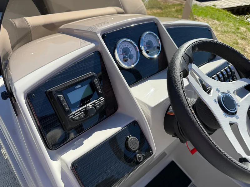 Slide: The Image of The image shows the helm of a 2027 Sylvan Mirage 822 LZ with modern instruments. - 16