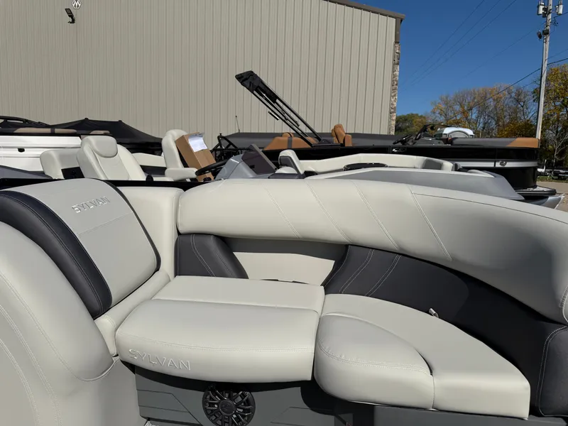 Slide: The Image of The image shows the seating of a 2027 Sylvan Mirage 822 LZ with gray and black upholstery. - 8