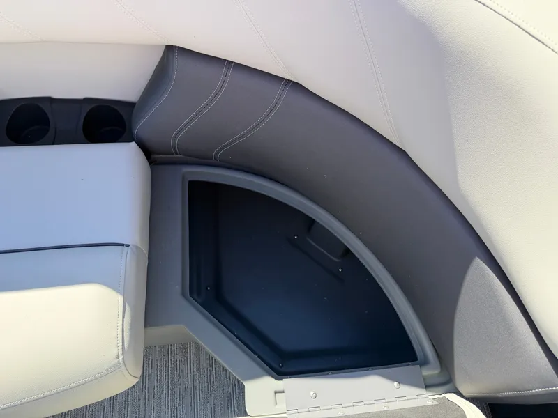 Slide: The Image of Close-up of a seating area with gray and white upholstery and cup holders. - 10