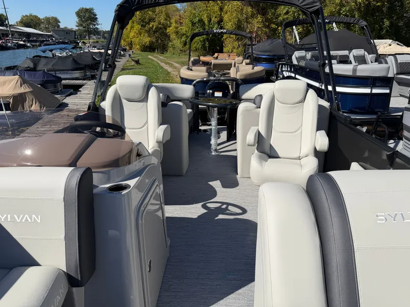 Slide: The Image of The image shows the interior of a 2027 Sylvan Mirage 822 LZ with luxurious seating and a helm. - 11