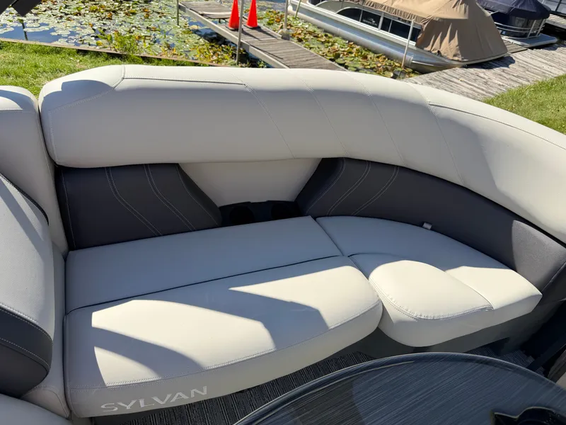 Slide: The Image of The image shows the seating area of a Sylvan Mirage 822 LZ boat with gray upholstery. - 20