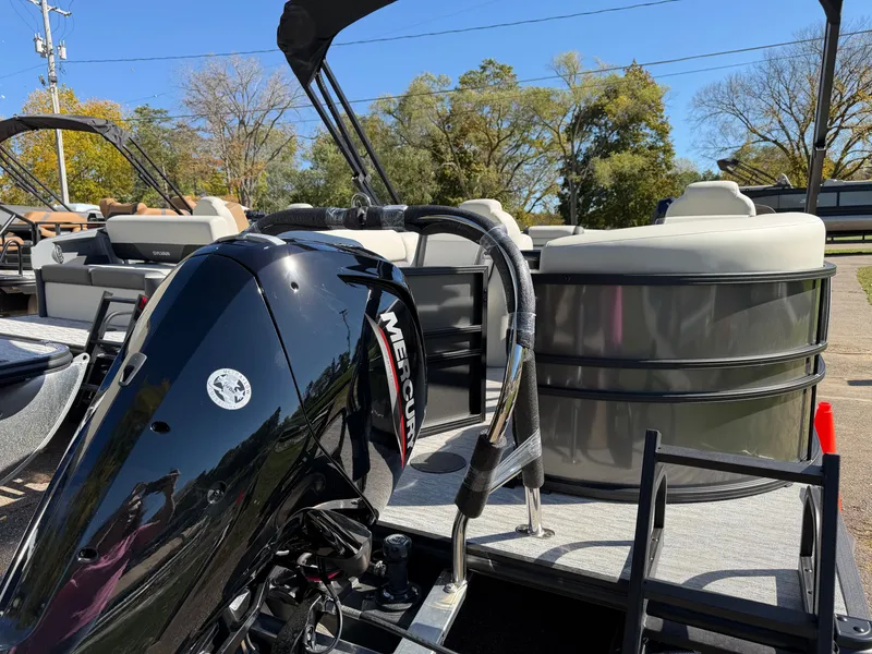 Slide: The Image of The image shows a Sylvan Mirage 822 LZ pontoon boat with a Mercury outboard motor. - 2