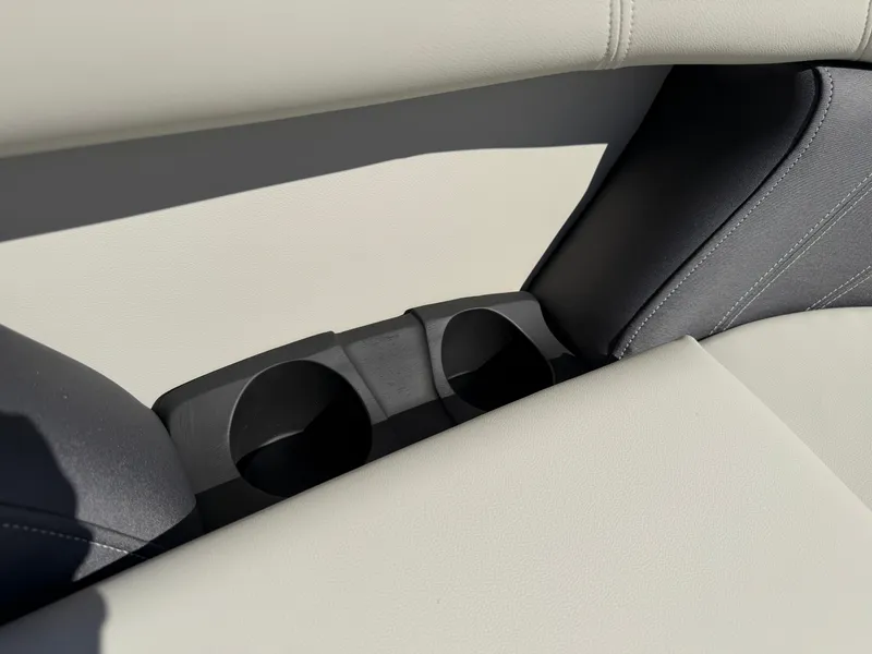 Slide: The Image of Close-up of beige and gray boat seats with built-in cup holders. - 9