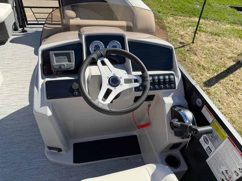Slide: The Image of The image shows the helm of a 2027 Sylvan Mirage 822 LZ with a steering wheel and gauges. - 15