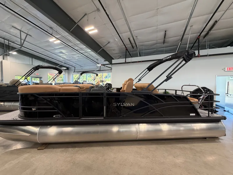 The Image of The image shows a Sylvan MIRAGE 822 CLZ DH pontoon boat in a showroom. - 0