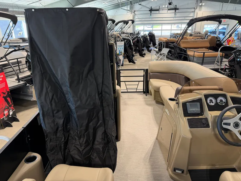 Slide: The Image of The image shows the interior of a Sylvan Mirage 822 LZ pontoon boat in a showroom. - 18