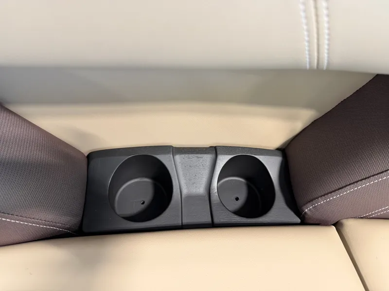 Slide: The Image of Close-up of two black cup holders in a beige boat seat. - 30