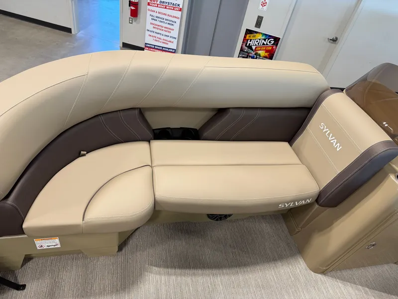 Slide: The Image of The image shows a beige and brown seating area in a Sylvan Mirage 822 LZ boat. - 13