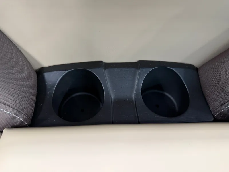 Slide: The Image of Two black cup holders are integrated into the beige upholstery of a boat. - 14