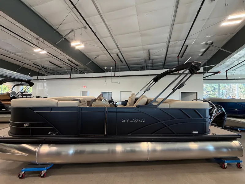 The Image of A Sylvan Mirage 822 LZ pontoon boat is in a showroom. It features a modern design and comfortable seating. - 0
