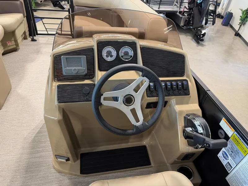 Slide: The Image of The image shows the helm of a 2027 Sylvan Mirage 822 LZ with a steering wheel and gauges. - 21