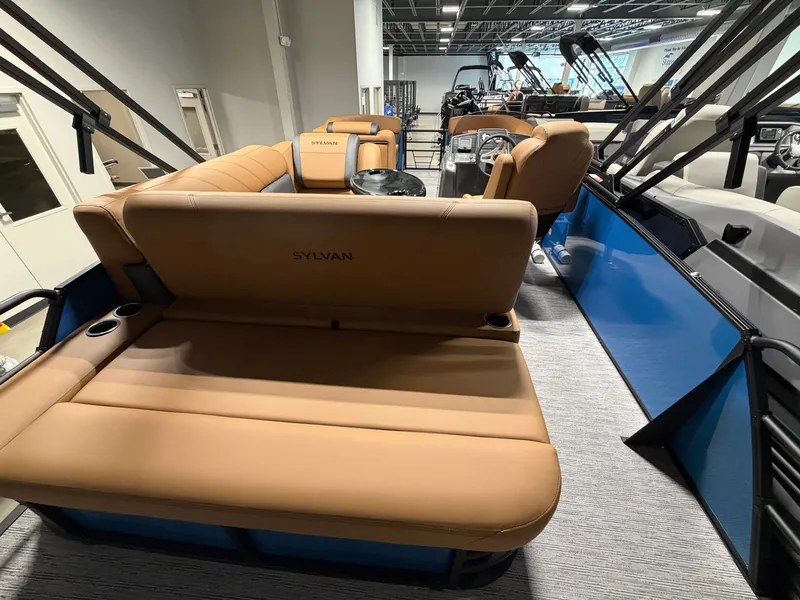Slide: The Image of The image shows the interior of a 2027 Sylvan Mirage 822 CLZ with beige seating and blue accents. - 22