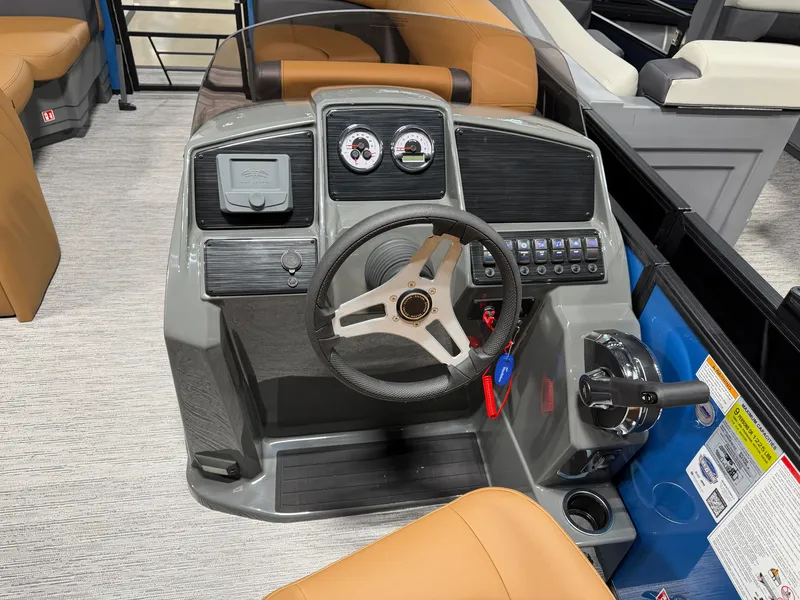 Slide: The Image of The image shows the helm of a 2027 Sylvan Mirage 822 CLZ with modern instruments. - 13