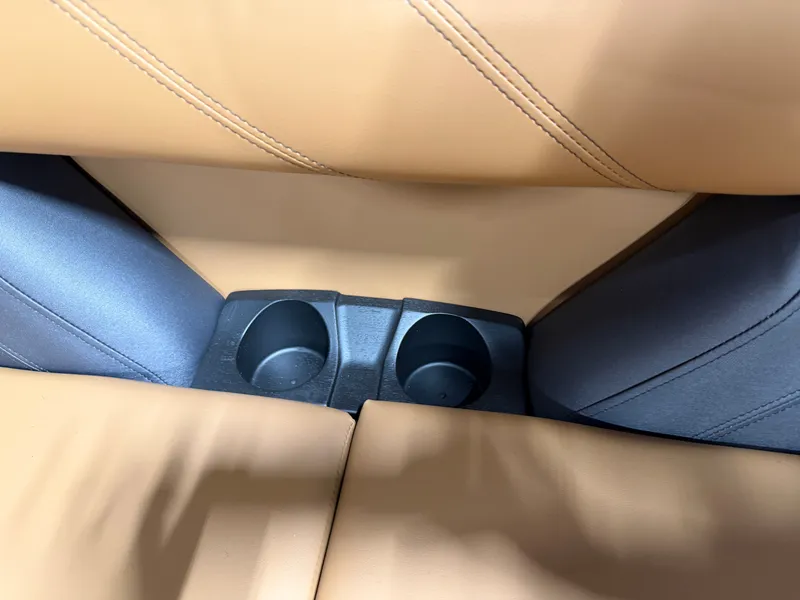 Slide: The Image of Close-up of two cup holders between beige seats on a boat. - 21