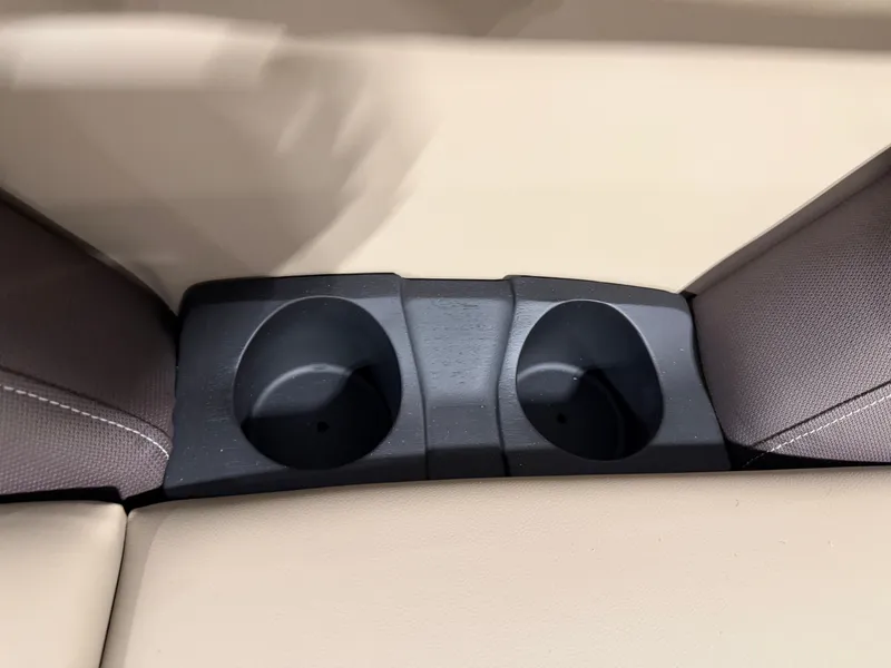 Slide: The Image of Close-up of two black cup holders between beige cushions on a boat. - 4