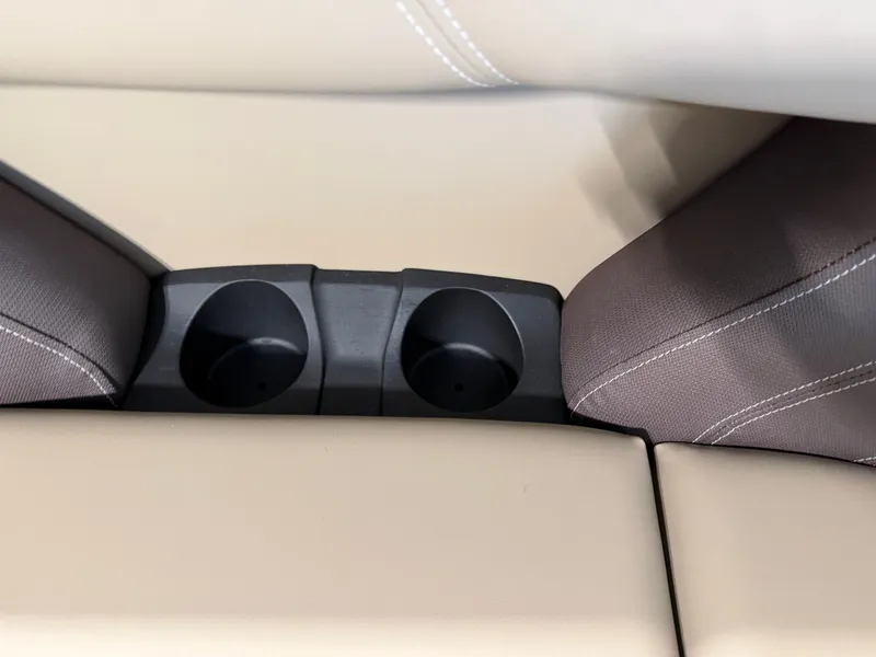 Slide: The Image of Close-up of two cup holders between beige and gray upholstery on a boat. - 7