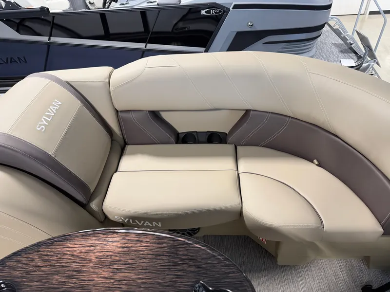 Slide: The Image of The image shows a beige and brown seating area in a Sylvan Mirage 820 CLZ DH boat. - 6