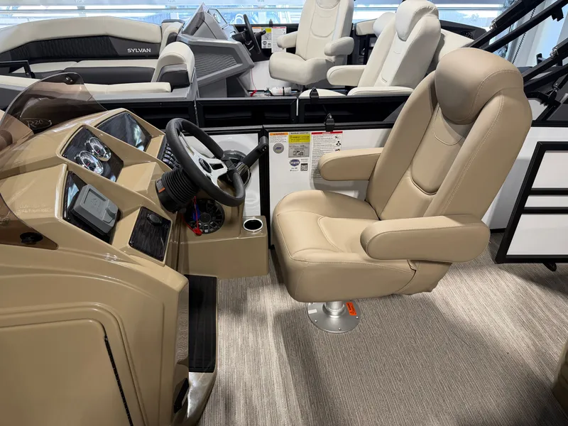 Slide: The Image of The image shows the helm of a 2027 Sylvan Mirage 820 CLZ DH with a beige leather seat. - 11