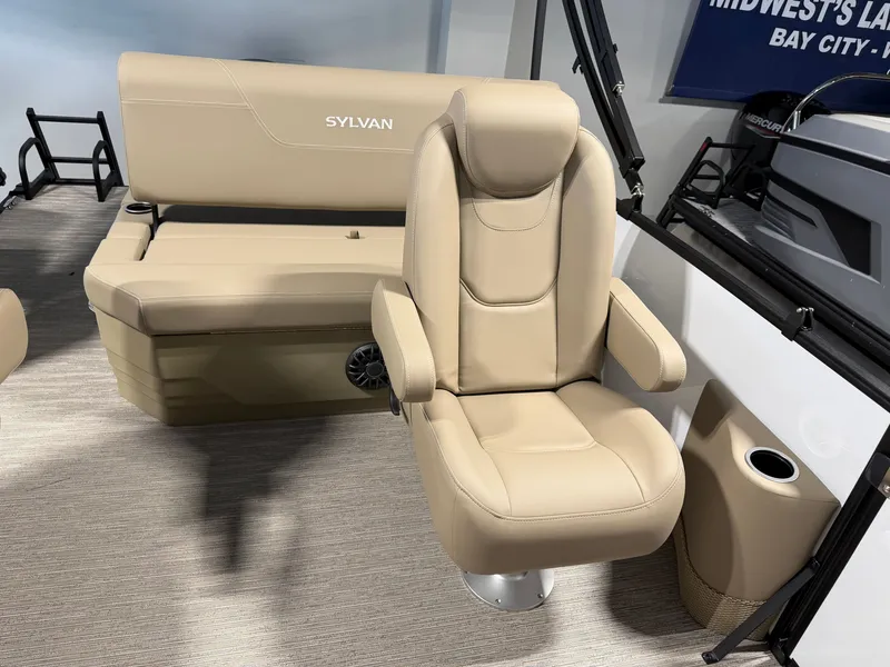 Slide: The Image of The image shows a beige upholstered seating area on a Sylvan Mirage 820 CLZ DH boat. - 17