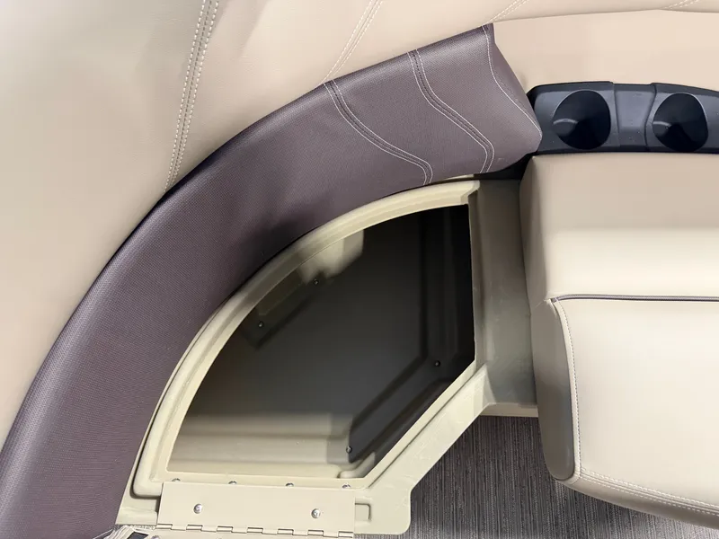 Slide: The Image of An open storage compartment in a Sylvan Mirage 820 CLZ DH boat, surrounded by beige upholstery. - 5