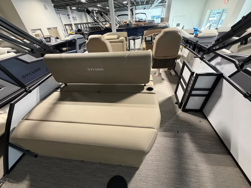 Slide: The Image of The image shows the interior of a Sylvan Mirage 820 CLZ DH boat with beige seating. - 20