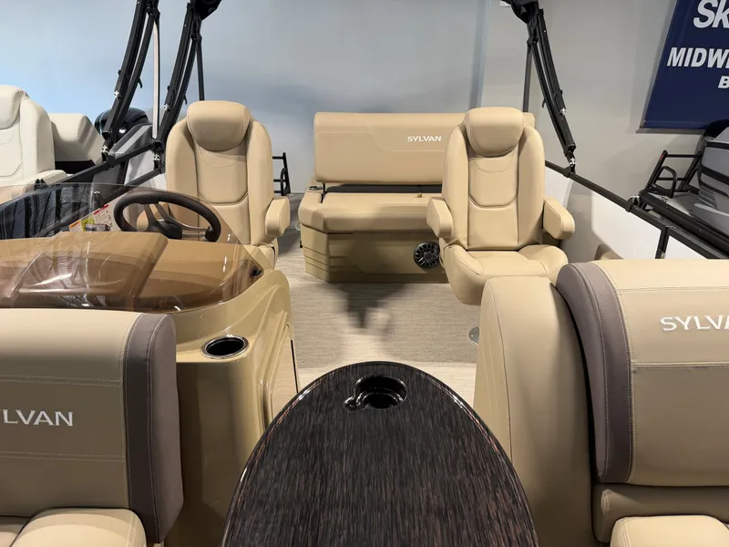 Slide: The Image of The image shows the interior of a 2027 Sylvan Mirage 820 CLZ DH boat with beige seating. - 9