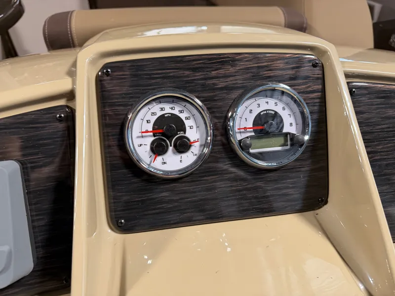 Slide: The Image of The image shows the dashboard of a Sylvan Mirage 820 CLZ DH boat with two round gauges. - 14