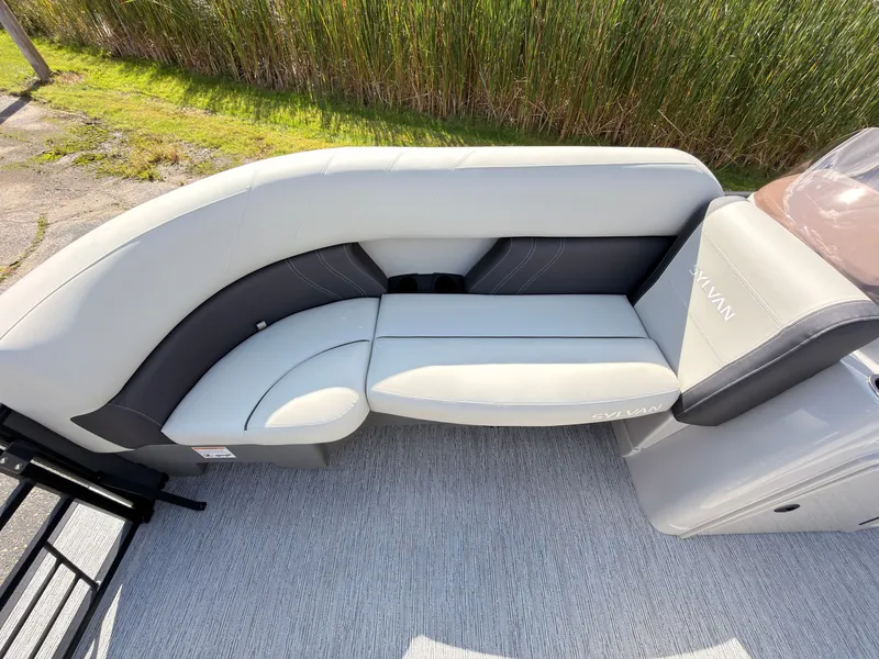 Slide: The Image of The image shows a sleek, gray seating area on a Sylvan Mirage 822 LZ boat. - 12