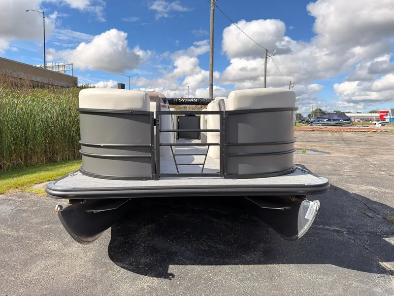 Slide: The Image of A Sylvan Mirage 822 LZ pontoon boat is parked on a lot under a cloudy sky. - 9
