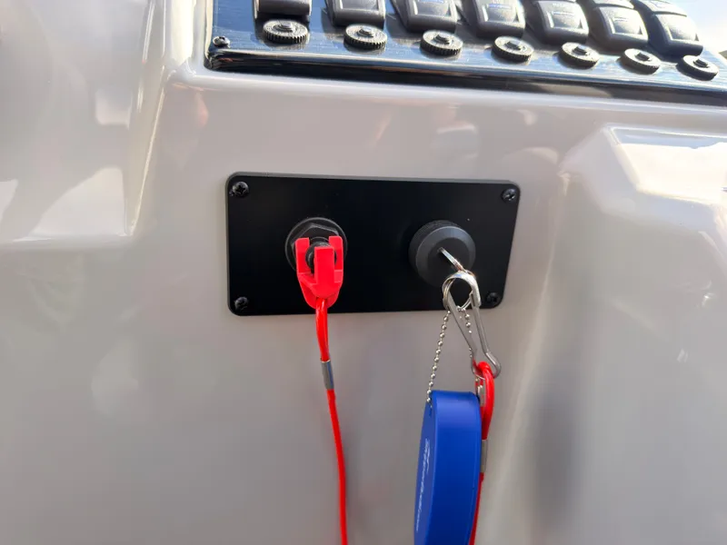 Slide: The Image of Close-up of a boat control panel with switches and a key fob. - 39