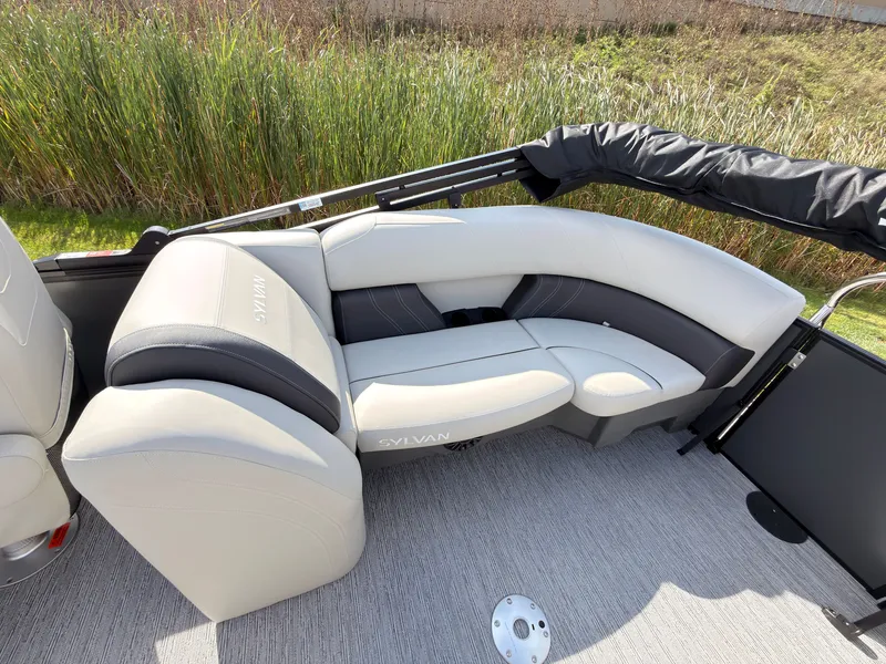 Slide: The Image of The image shows an elegant seating area on a Sylvan Mirage 822 LZ boat, surrounded by reeds. - 45
