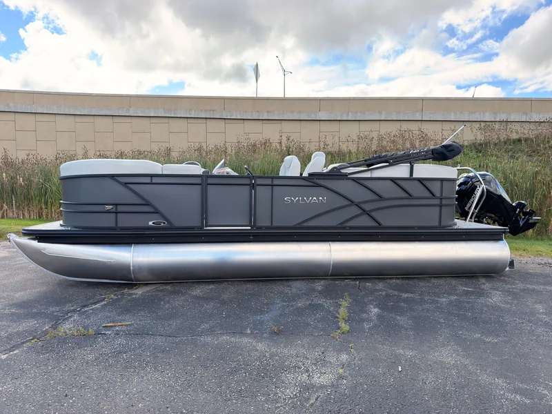 Slide: The Image of A 2027 Sylvan Mirage 822 LZ pontoon boat is parked on a lot. It features a modern design with gray accents. - 3