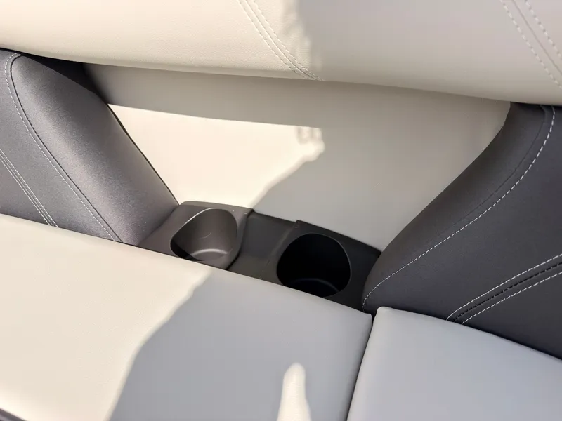Slide: The Image of Close-up of a boat seat with two cup holders, featuring light and dark upholstery. - 25