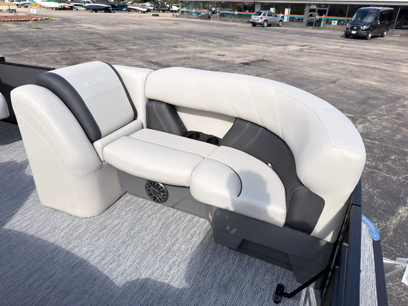 Slide: The Image of The image shows an elegant, cushioned seating area on a Sylvan Mirage 822 LZ pontoon boat. - 18