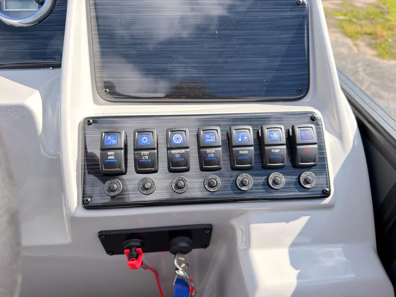 Slide: The Image of The dashboard of a Sylvan Mirage 822 LZ with various switches and buttons. - 38